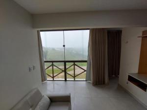 a living room with a large window with a view at Apartamento sonhos da serra bananeiras in Bananeiras +20 photos