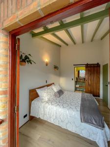 a bedroom with a bed and a brick wall at Hotel Casa Dulces del Jardín in Jardin