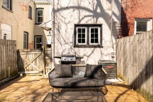 a chair sitting on a patio in front of a building at 3 minutes to downtown w/Patio, Art, Fire Pit, BBQ in Lancaster