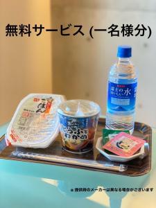 a tray with a bottle of water and some food at LUXe in Higashihiroshima