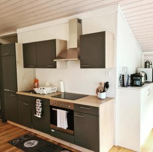 a kitchen with a stove top oven in a room at Muota River & Industry Apartment by Nature Apartments Switzerland in Muotathal
