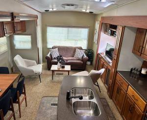 a kitchen and living room of an rv at Well Appointed American Style Park Home in Kempsey