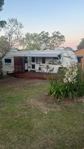 a white rv parked in a yard with a patio at Well Appointed American Style Park Home in Kempsey