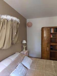 a bedroom with a bed and a book shelf at Rêve d’Emma in Plan-dʼOrgon