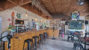 a bar in a restaurant with chairs and tables at Tiki Bantayan Cebu Tourist Inn Inc in Pooc