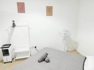 a white bedroom with a bed and a fan at S3 2Room Sunway Geo 1-8PAX Sunway Medical Centre in Kampong Penaga