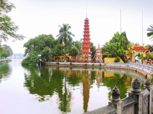 a bridge over a body of water with a temple at Da Tree Homestay in Hanoi