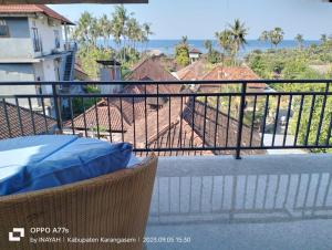 a balcony with a view of a house at Pondok Wisata Balty Bali in Amed