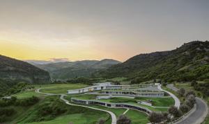 a building on a hill with a winding road at Concept Hotel by COAF in Debed