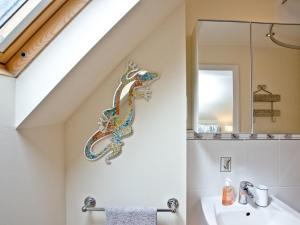 a bathroom with a statue of a seahorse on the wall at Coastal Gem in Weymouth