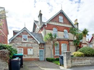 an old house with a palm tree in front of it at Coastal Gem in Weymouth