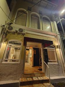 una entrada a una casa con ventanas y una puerta en Sunshine House en George Town