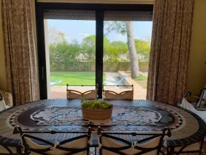 a table in a room with a large window at Villa Rossi in Polignano a Mare