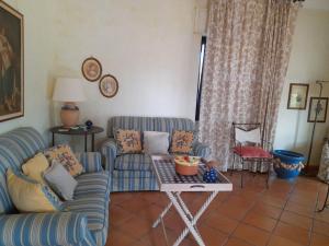 a living room with two couches and a table at Villa Rossi in Polignano a Mare