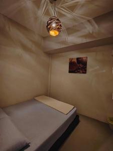 a small room with a bed and a light at Sunshine House in George Town