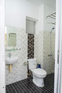 a bathroom with a toilet and a sink at An Gia Hotel Tây Ninh in Tây Ninh