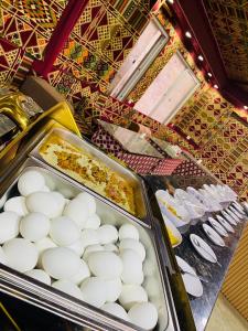 a buffet filled with eggs and other food at Panorama Wadi Rum in Wadi Rum