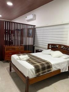 a bedroom with a large bed with a wooden frame at Family Apart Studio in Puerto Baquerizo Moreno