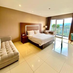 a hotel room with a bed and a couch at Clove Hotel Bandung in Bandung