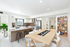 a kitchen with a large wooden table and chairs at Agathas at Seacombe Gardens in Sturt