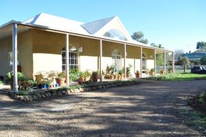 a building with potted plants on the side of it at Strawbale House Bacchus Marsh in Bacchus Marsh