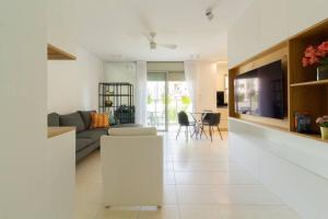 a living room with a couch and a tv at Jaffa's Hideaway - Lux 2BR w/balcony and parking! in Tel Aviv