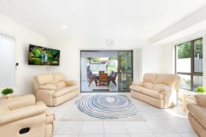 a living room with two chairs and a couch at Agathas at Seacombe Gardens in Sturt