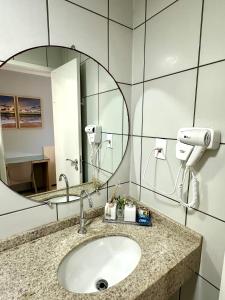 a bathroom with a sink and a mirror at Barreirinhas Gran Lençóis Flat in Barreirinhas