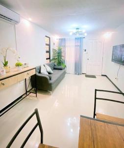 a living room with a couch and a table at Sönmez Private Villa in Cavite