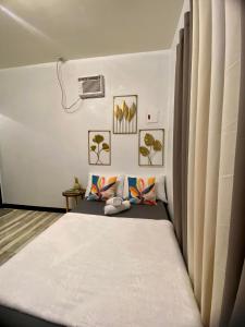 a bedroom with a bed and a window at Shanti's Inn in General Luna