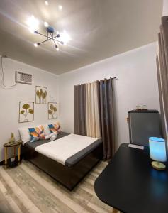 a bedroom with a bed and a television in it at Shanti's Inn in General Luna