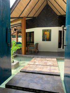 an open door of a house with a patio at Villa Amuntai with Pool & Jacuzzi in Dinalupihan