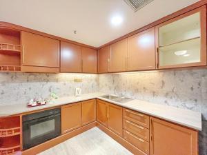 a kitchen with wooden cabinets and a sink at The Avenue M in Johor Bahru