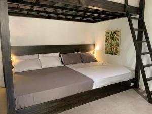 a bedroom with a bunk bed with a ladder at Villa Amuntai with Pool & Jacuzzi in Dinalupihan