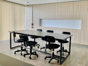 a conference room with a large table and chairs at Second Home in San Salvador