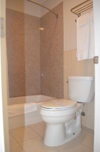 a bathroom with a toilet and a bath tub at Galaxy Inn in Los Angeles
