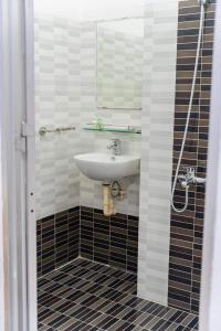 a bathroom with a sink and a mirror at An Gia Hotel Tây Ninh in Tây Ninh