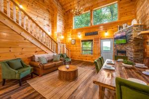 a living room in a log cabin with a table and chairs at Heavenly Heights by Ghosal Luxury Lodging in Sevierville