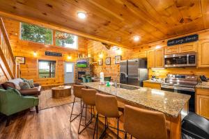 a kitchen with a large island in a cabin at Heavenly Heights by Ghosal Luxury Lodging in Sevierville