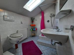 a bathroom with a sink and a toilet at Wiesenheimhof - Apt 1 in Terento