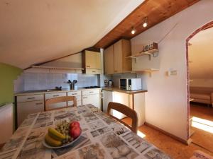 a kitchen with a table with a bowl of fruit on it at Wiesenheimhof - Apt 1 in Terento