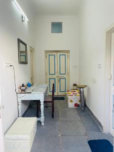 a room with a table and a blue door at Atithya in Udaipur
