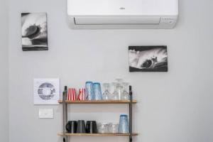 a room with a white ceiling fan and a shelf at Lovely "Driftwood Taft" Apartment Beach & Everything few Minutes walk! Central Glenelg in Glenelg