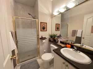 a bathroom with a toilet and a sink and a shower at Metrotown Exquisite 1 Bed Room Private Entire Suite with Separated Entrance in Burnaby