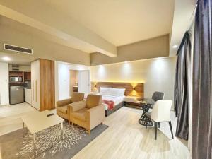 a hotel room with a bed and a living room at The Avenue M in Johor Bahru