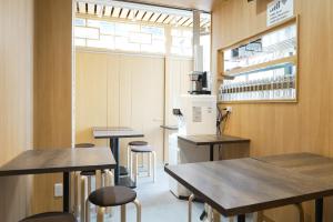 a laboratory with tables and stools in a room at Lodging Tokyo Shibamata in Tokyo