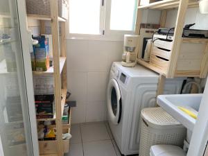 a laundry room with a washing machine and a sink at Holiday Home Benidorm with sea views, roof terrace and swimming pool in Benidorm