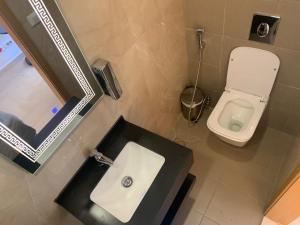 a bathroom with a sink and a toilet at Bliss 3000 Furnished Studios in Beirut