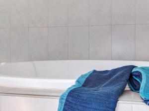 a blue towel is sitting on a bath tub at 14 person holiday home in Idestrup in Marielyst