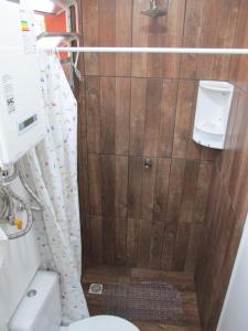 a small bathroom with a toilet and a shower at Cabana Costa Rural in Gramado